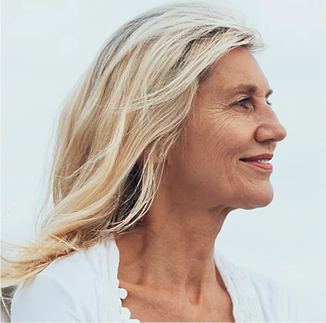 laughing couple walking arm in arm on beach